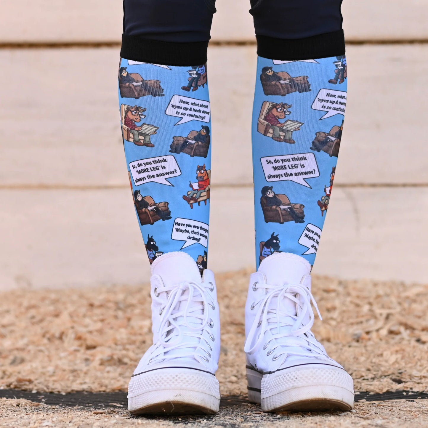 Person wearing blue socks with cartoon character design on a blue background
