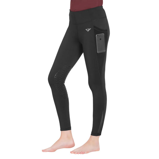 Model wearing charcoal colored riding tights with a mesh side cell phone pocket