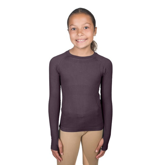 young equestrian wearing a purple-ish colored seamless long sleeve shirt with thumb holes.