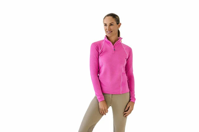 Woman wearing a pink long sleeve riding shirt on a white background