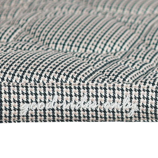 Close-up of a textured fabric with a houndstooth pattern.