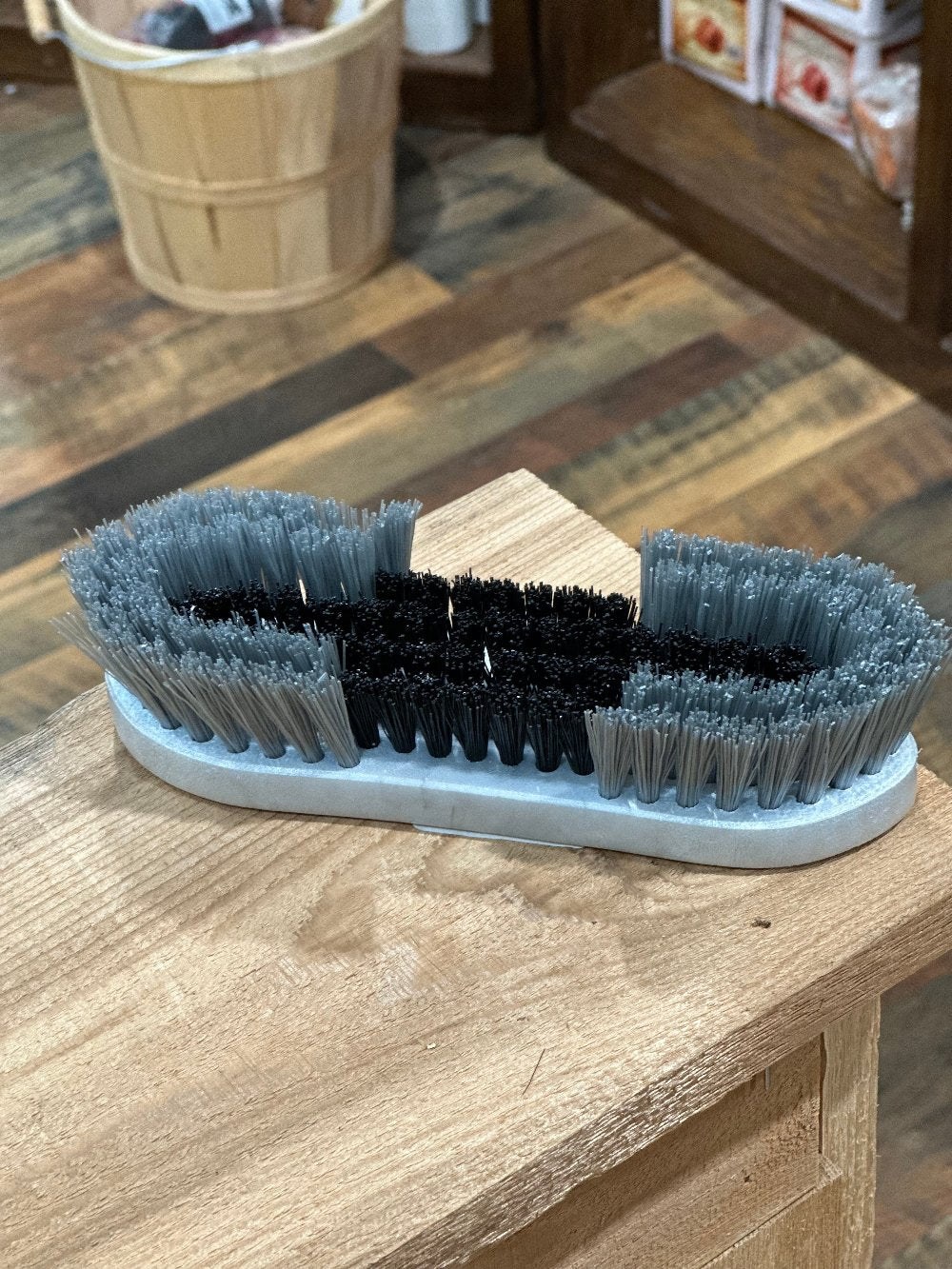 hand held grooming brush with different lengths of bristles - grey