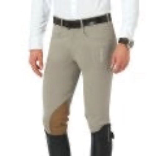 Men's tan riding breeches with darker knee patch. Model is wearing a dark belt and tall equestrian riding boots