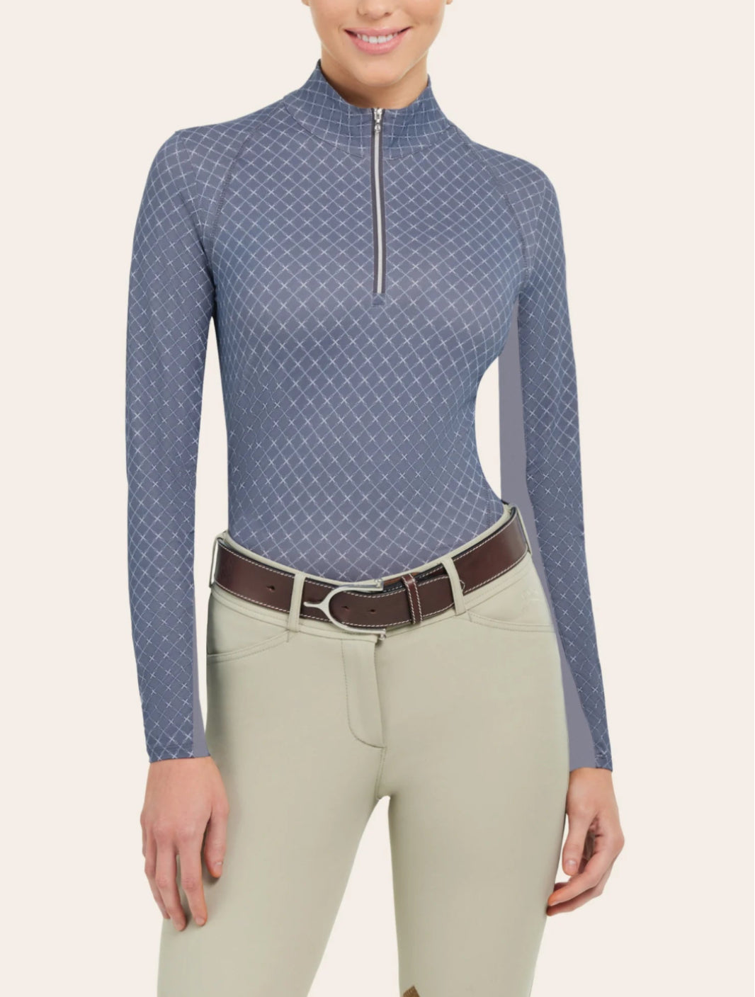 Woman wearing blue long sleeve shirt with white crosshatching pattern throughout shirt, and gold quarter zipper.