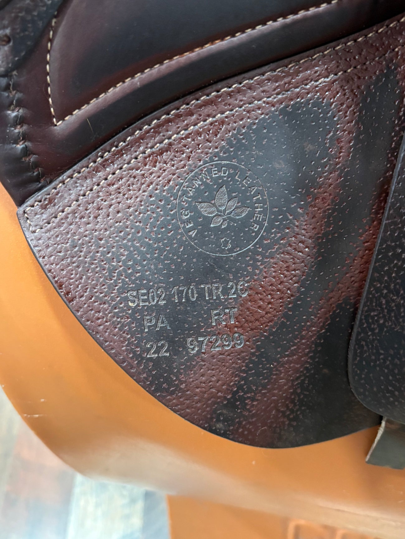 Close up of the stamp on the flap of an english saddle