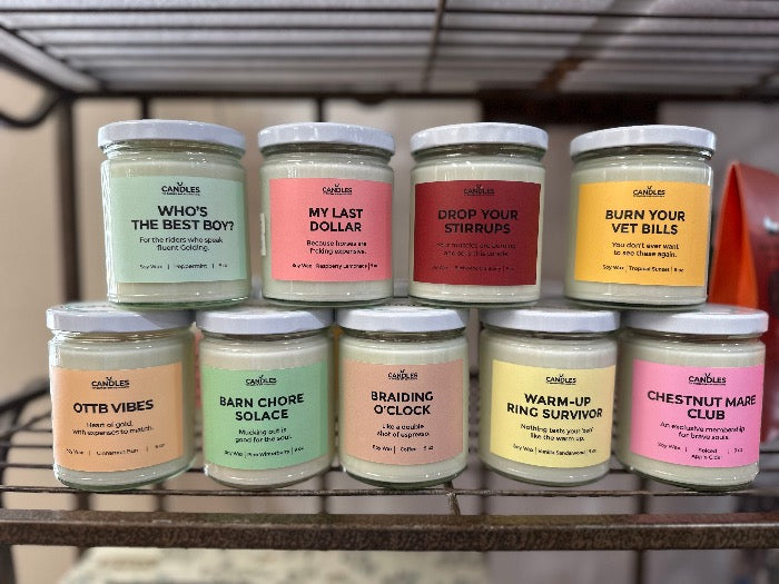front view of 9 candles stacked up all with different names