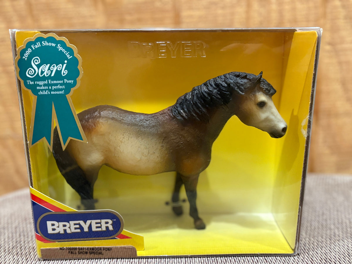 Breyer model horse figure in its original window box packaging, featuring a brown and tan horse with a black mane, set against a yellow background.
