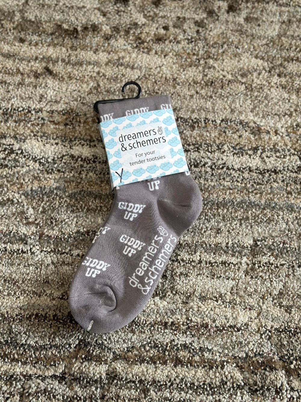 tan crew socks with words "giddy up" written in white