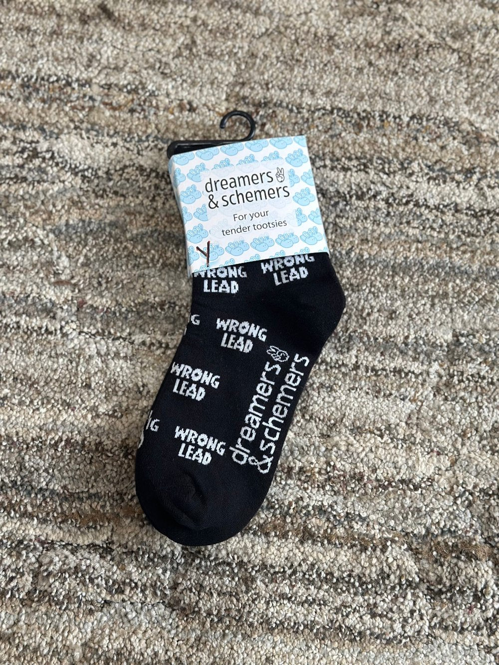Black crew socks with words "wrong lead" in white lettering