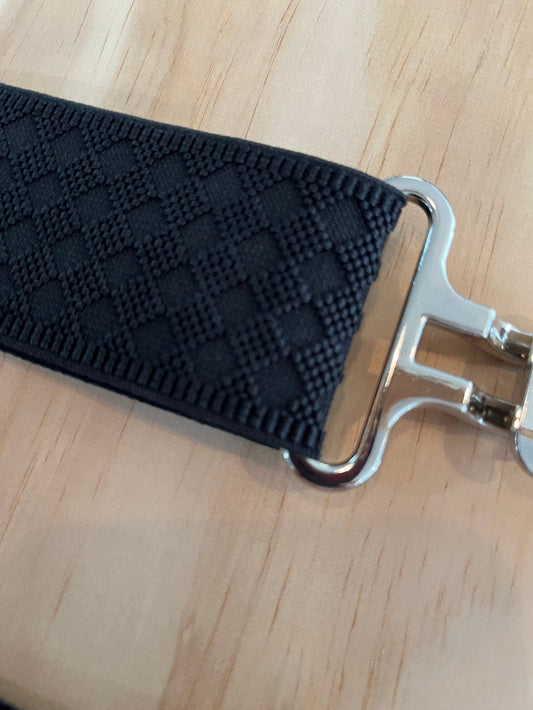 close up of a black elastic belt with a raised diamond pattern.