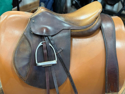 English saddle with two tones of leather (dark and light).  Pictured with stirrups, leathers and a leather girth