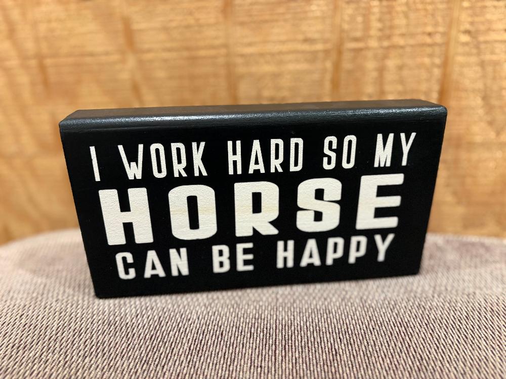 Black wooden block with "I work hard so my horse can be happy" written in white