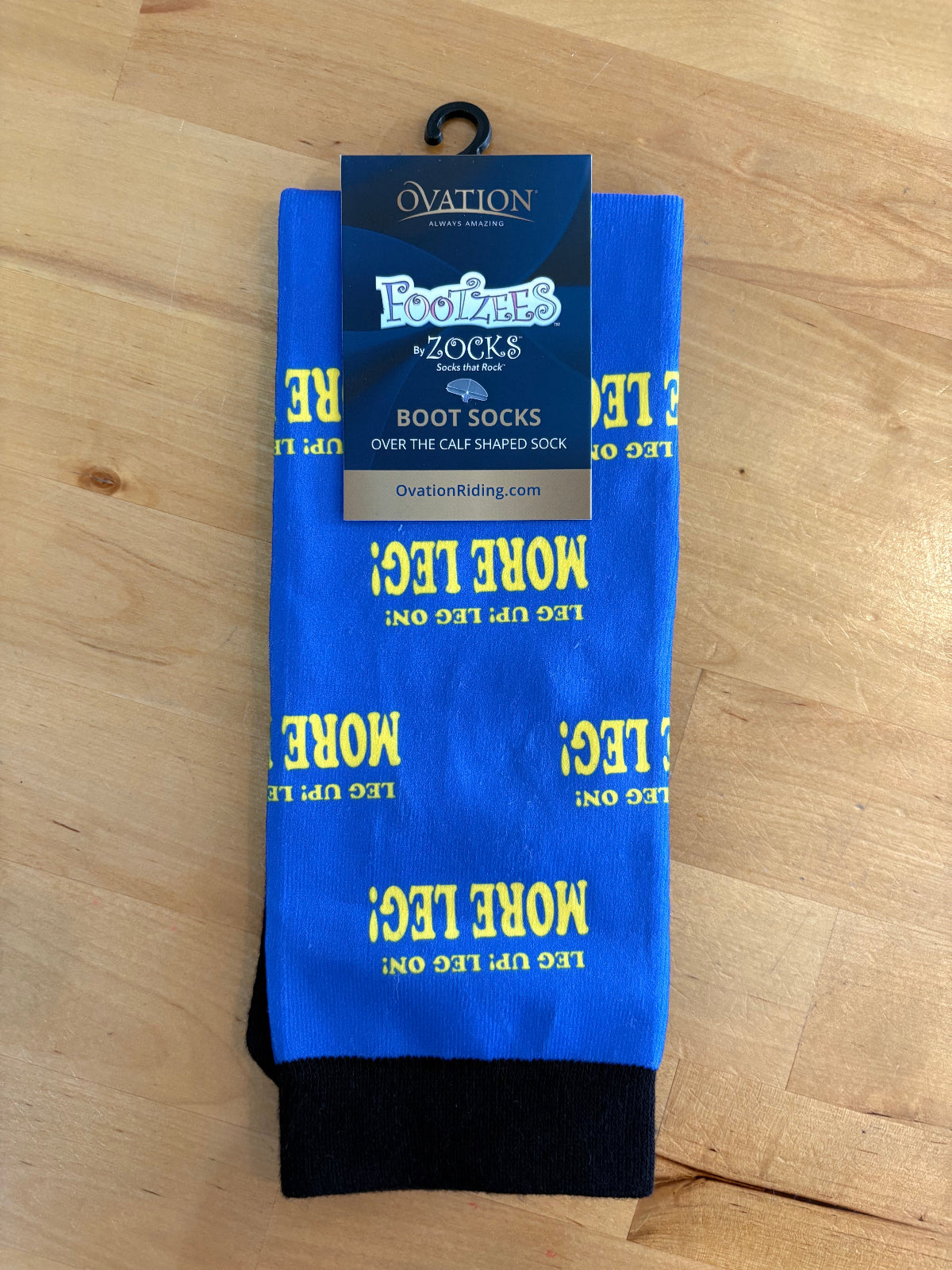 Blue socks with yellow text "More Leg!"