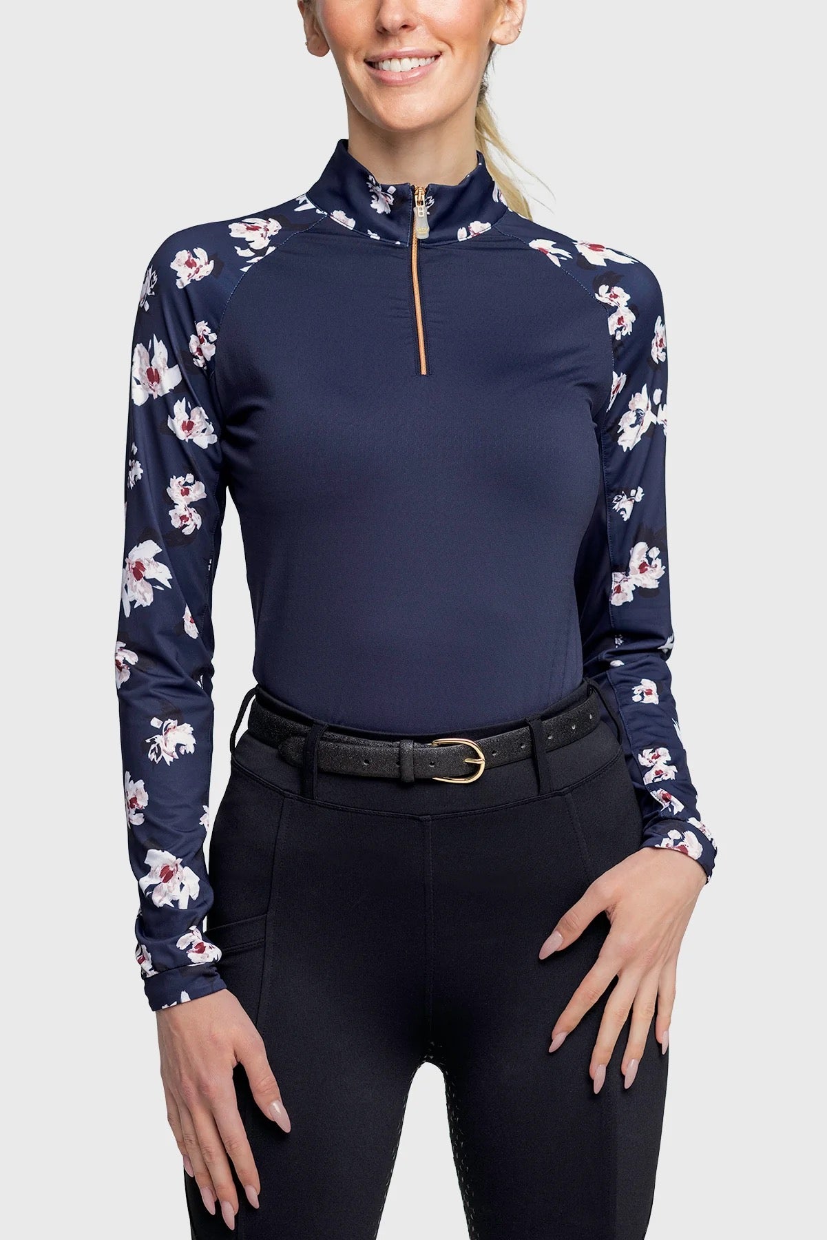 Woman modeling a navy 1/4 zip top with floral sleeves.