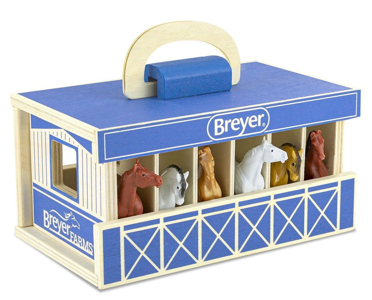blue wooden stable toy with carry handle.  Six stalls with six different colored horses facing out
