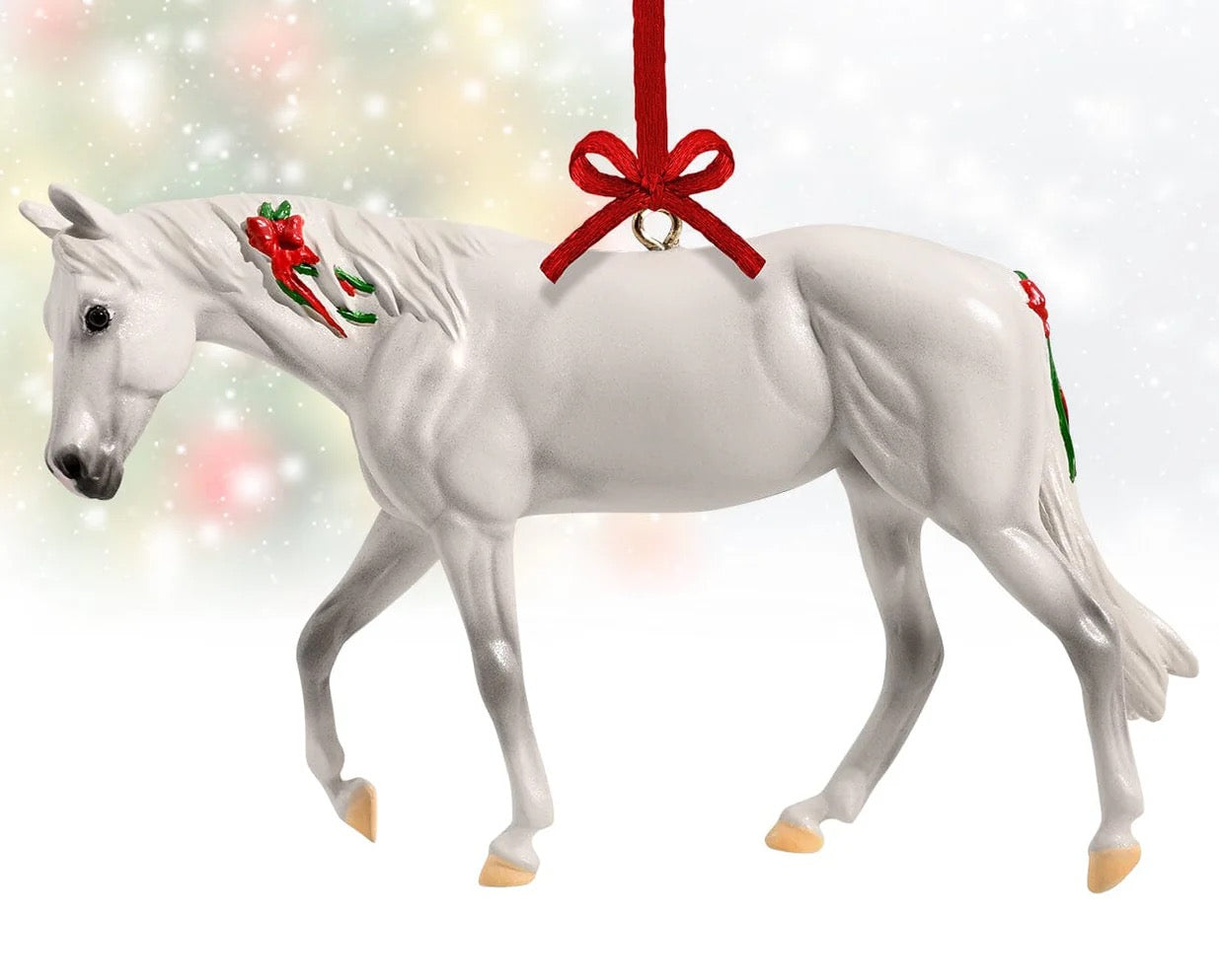Beautiful white horse Christmas ornament hanging from a red silk bow.  Red bows painted into the horse's mane and tail.