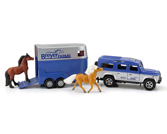 Breyer Farms model Land Rover vehicle pulling a horse trailer.  Palomino and bay colored horses included