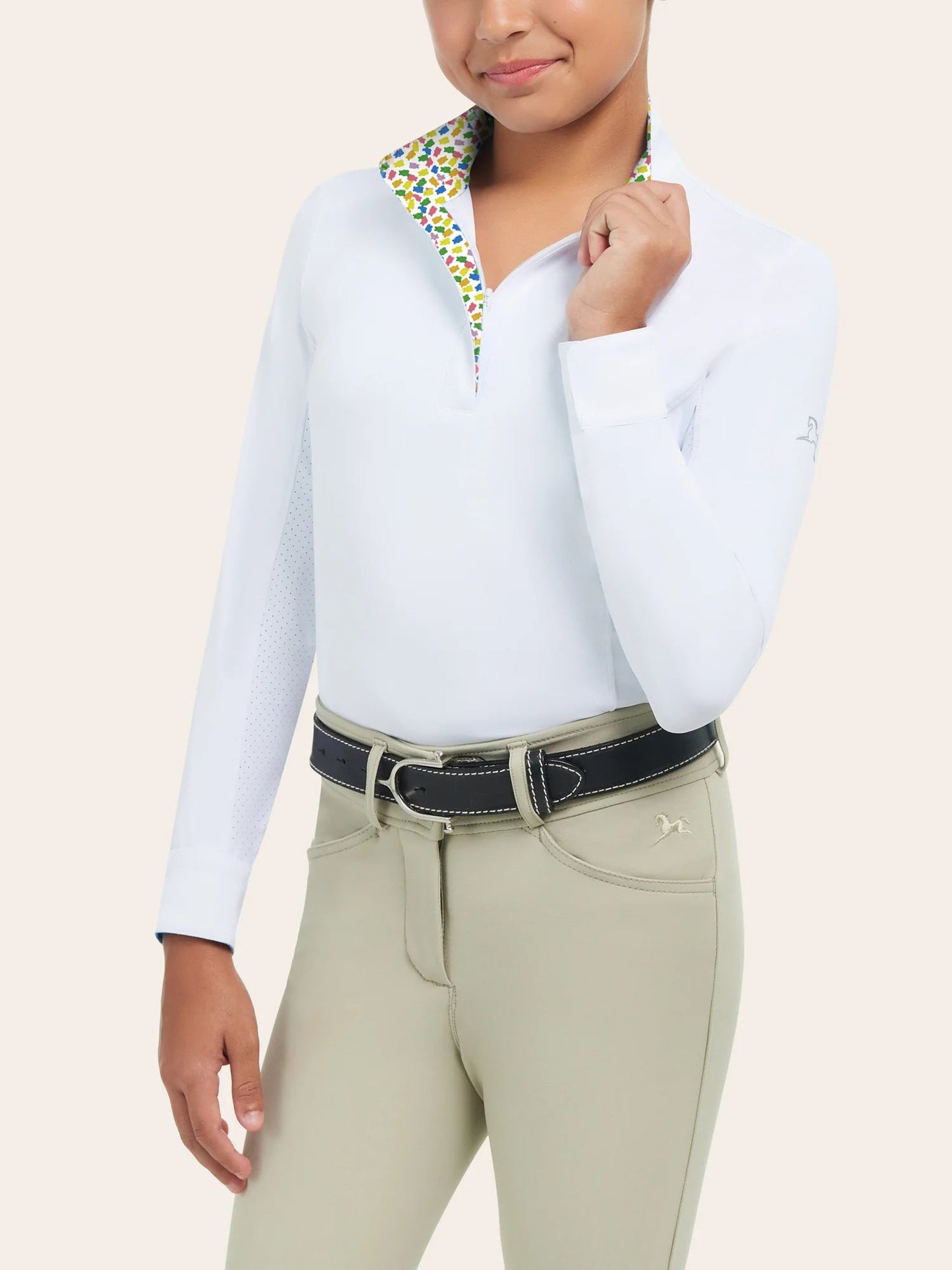 Young equestrian modeling show clothes (white long sleeve shirt with tan knee patch pants)