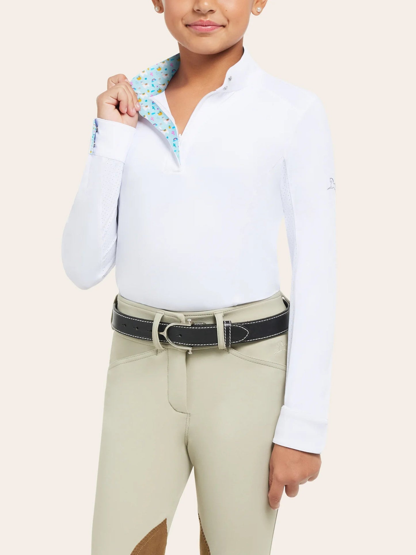 Young equestrian modeling show clothes (white long sleeve shirt with tan knee patch pants)