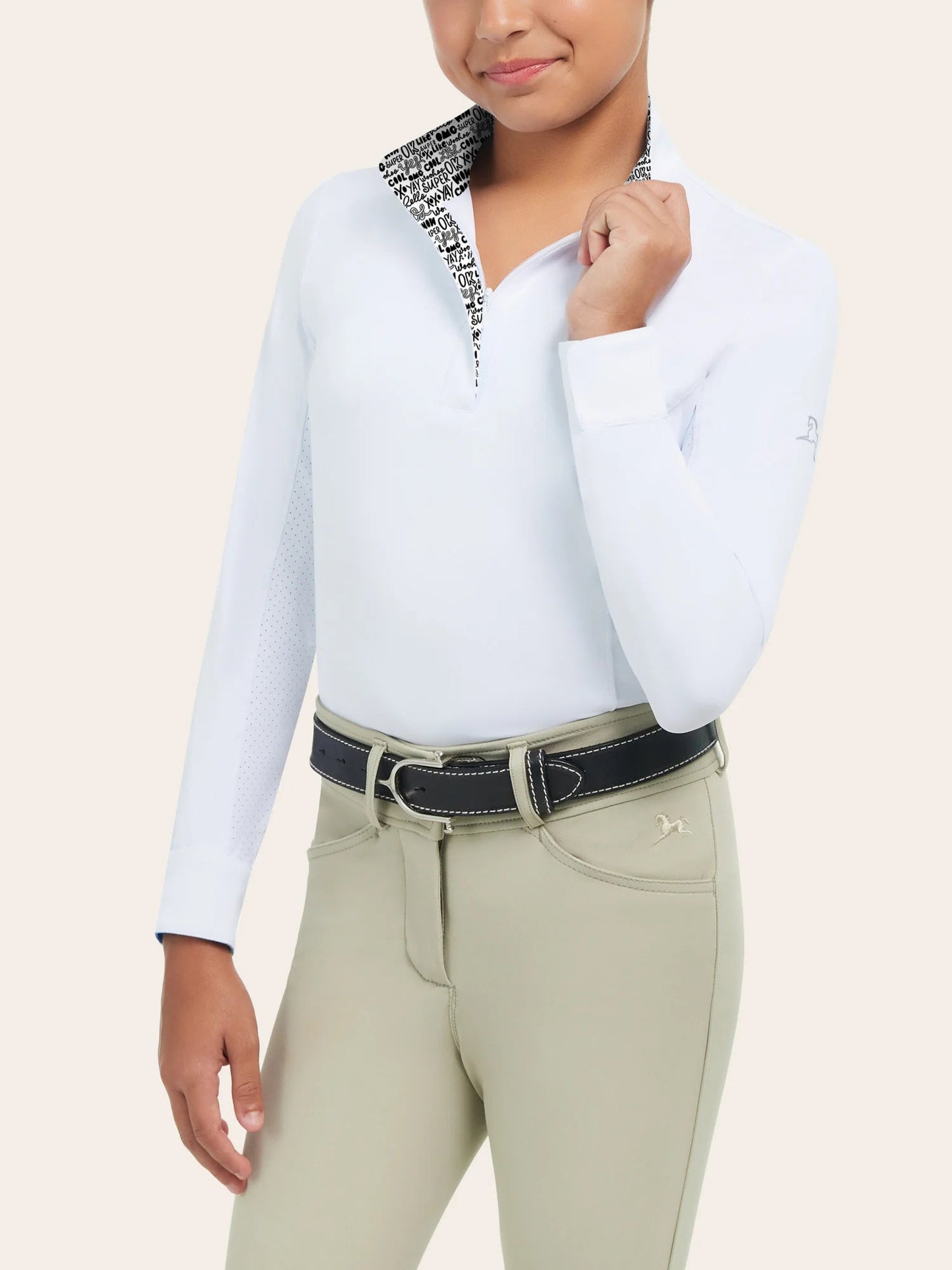 Young equestrian modeling show clothes (white long sleeve shirt with tan knee patch pants)