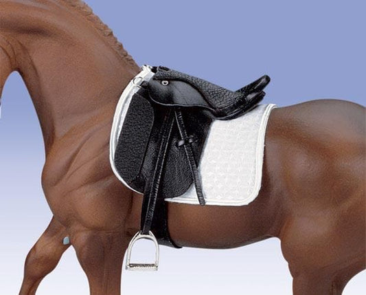 Horse with a black saddle and white saddle pad on a clear background