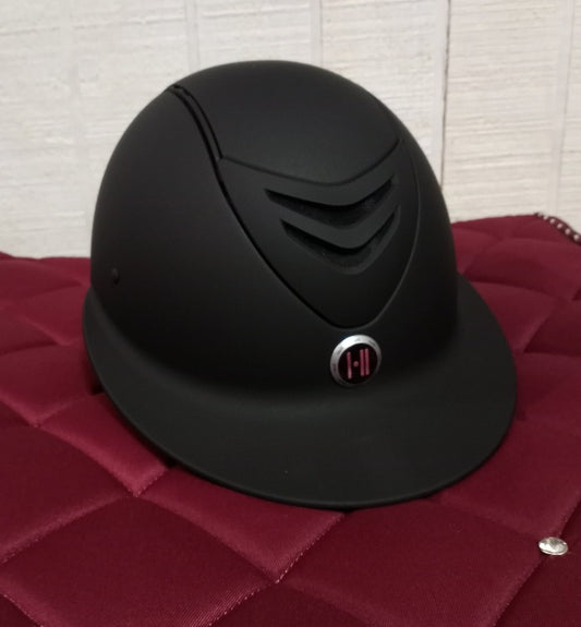 Black wide brim equestrian riding helmet showing the One K logo.  Edit alt text
