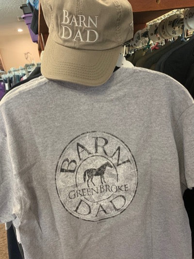 Barn Dad cap is tan with creme colored embroidered words. Also showing the grey "Barn Dad. Green Broke." shirt.