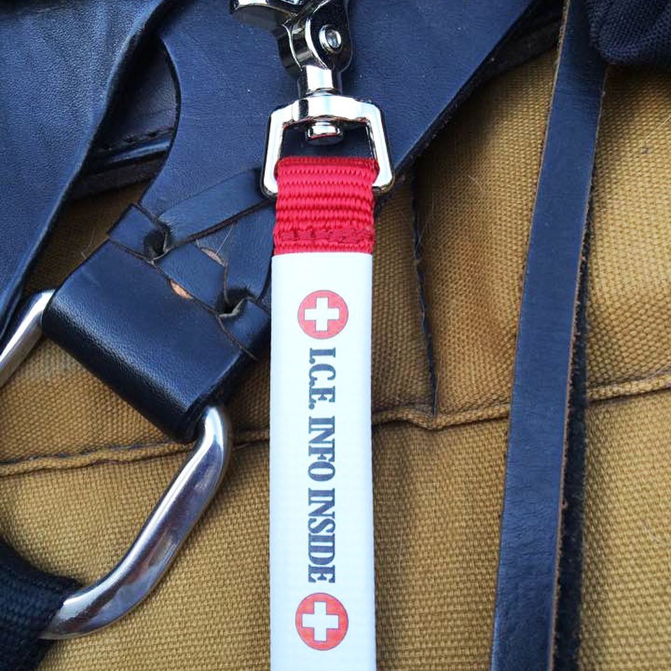 red info tag clipped to a saddle