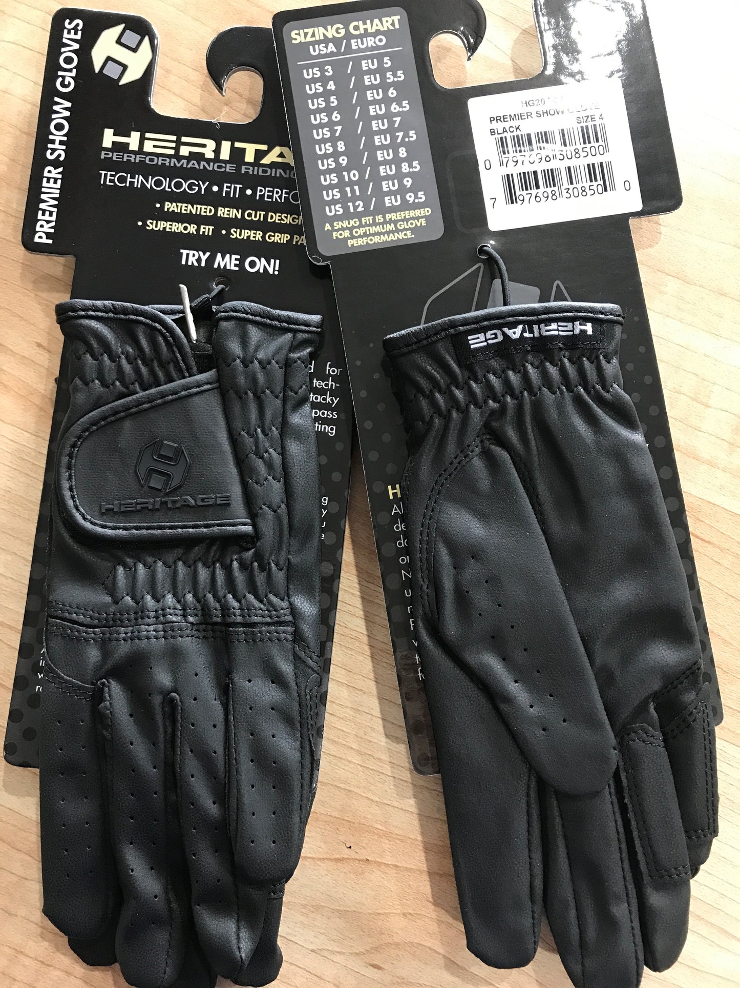 Black equestrian show gloves with velcro wrist. Heritage logo on package hanger and velcro wrist closure.