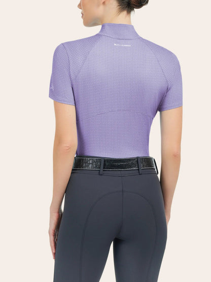 back view of a model wearing a short sleeve lavender shirt with grey riding pants