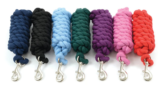 Seven colors of cotton lead ropes on a white background.  Navy, black, lt blue, hunter green, purple, pink and red.