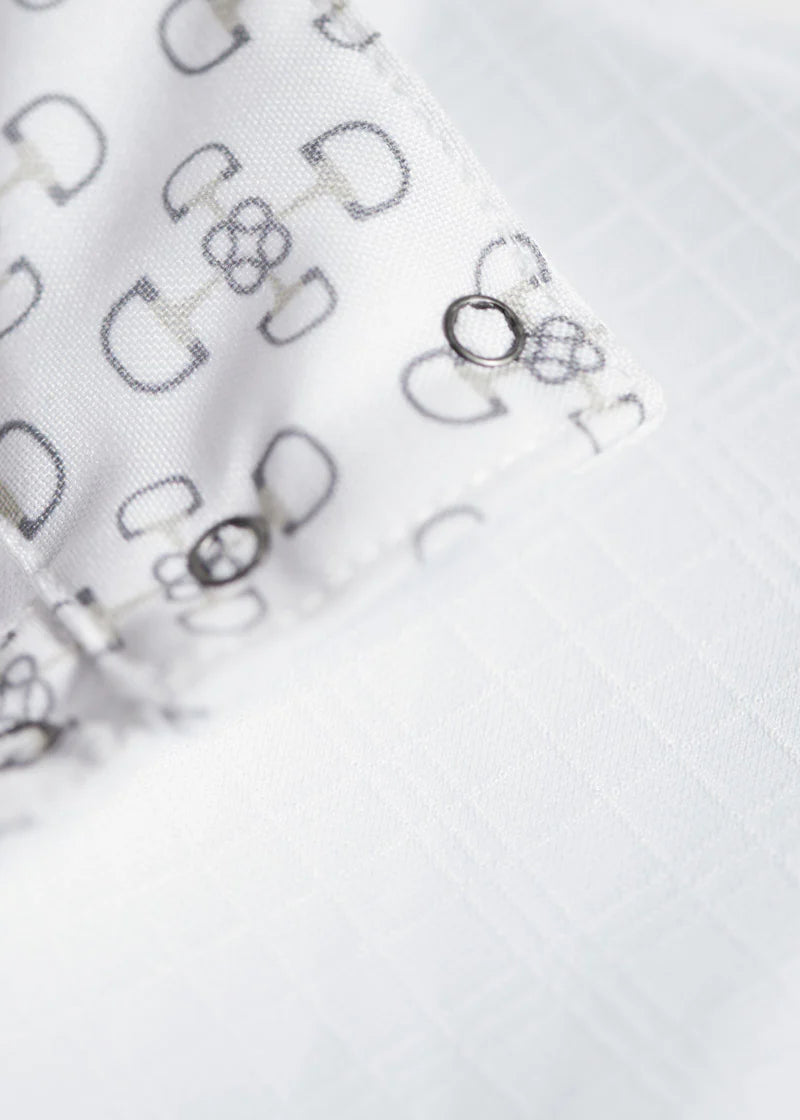 Close view of the print patter from the inside collar of an equestrian show shirt