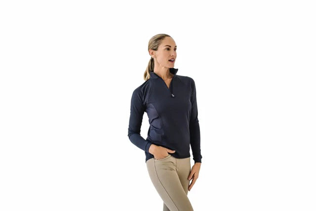 Woman wearing a black long-sleeve shirt and beige pants on a white background