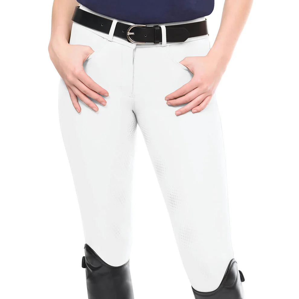 White riding pants with a black belt and black boots on a white background