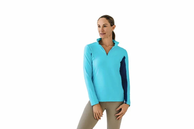 Woman wearing a long sleeve blue and navy riding sunshirt on a white background