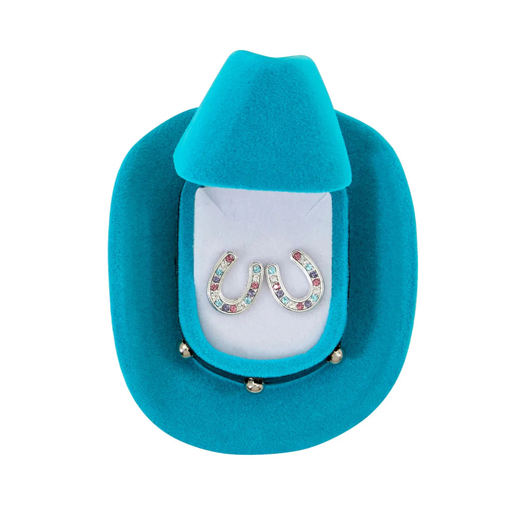 Turquoise cowboy hat with a display case containing colorful horseshoe earrings on a white background