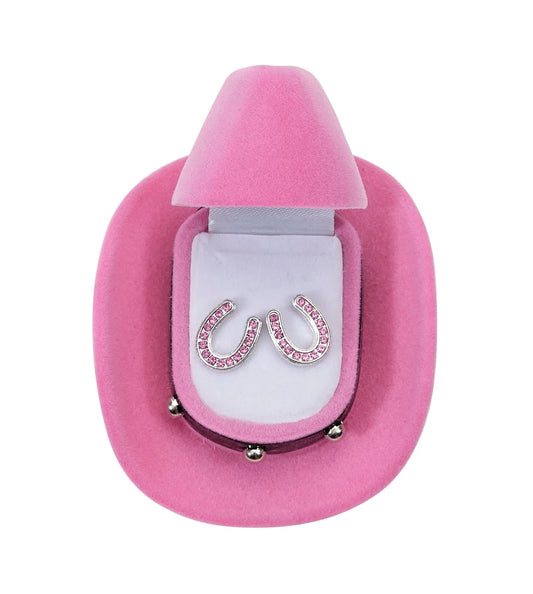 Silver horseshoe earrings with pink stones in a pink and white cowboy hat shaped box