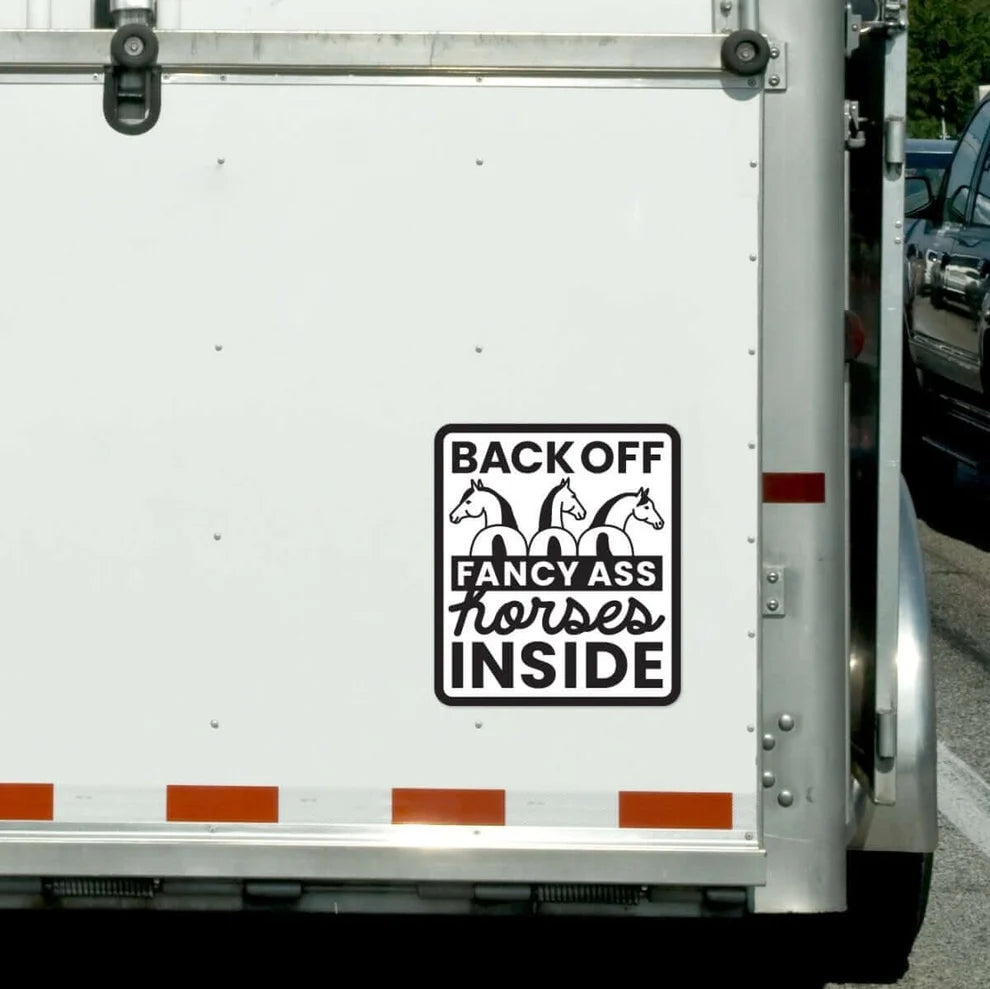 Trailer with a humorous decal about horses on a white background