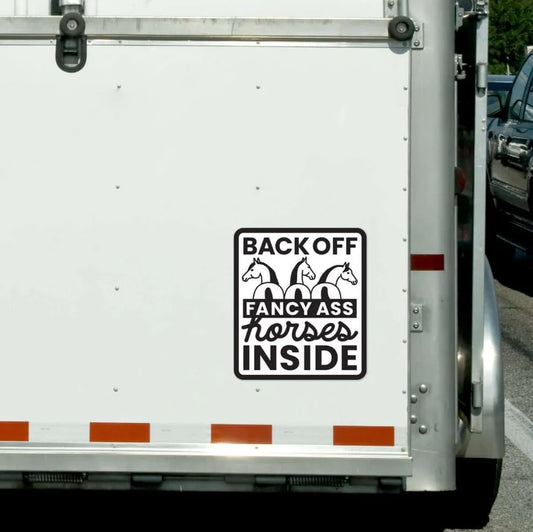 Trailer with a humorous decal about horses on a white background