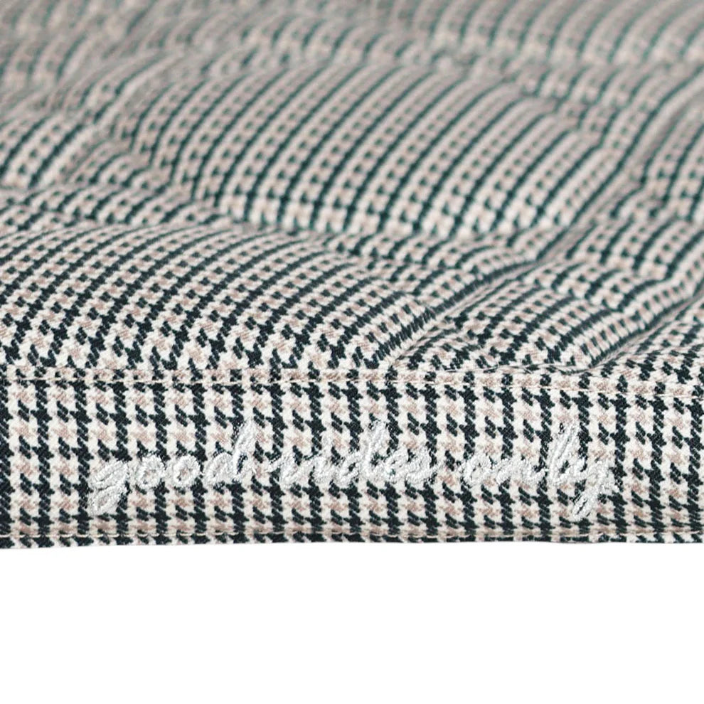 Close-up of a textured fabric with a houndstooth pattern.