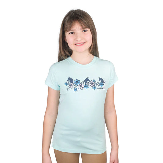 Young girl wearing a light blue t-shirt with a floral horsey design on a white background