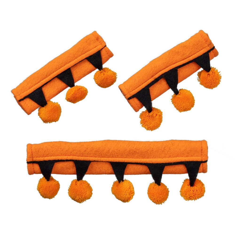 Three orange halter attachments with black accents and pom-poms on a white background