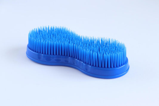 Blue plastic brush for grooming horses