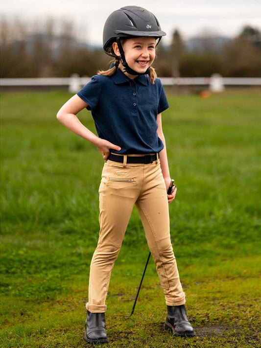 Young girl  dressed to ride her horse.