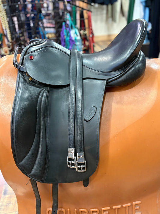Black leather saddle on a horse mannequin with a blurred background
