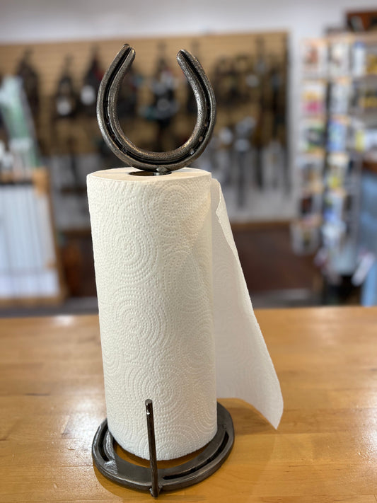 Paper towel holder with a horseshoe design on a wooden surface
