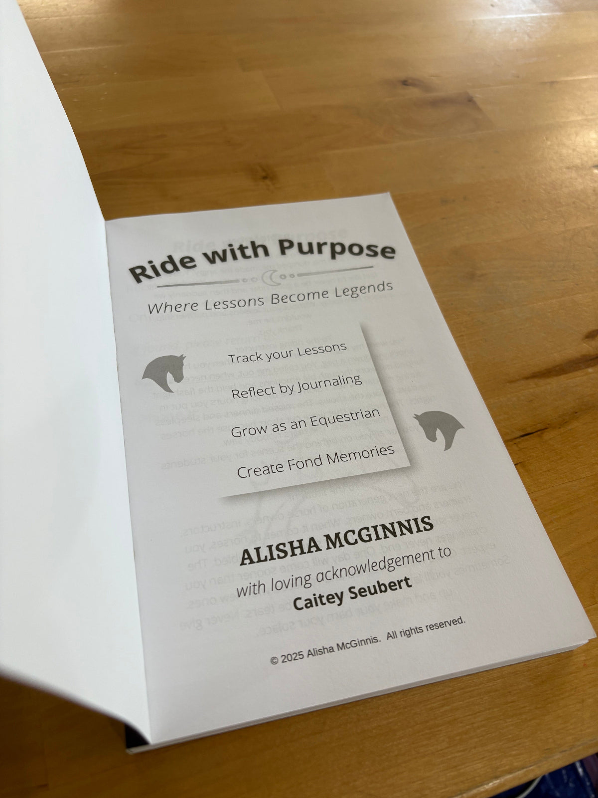 Inside flap of book titled 'Ride with Purpose' on a wooden surface