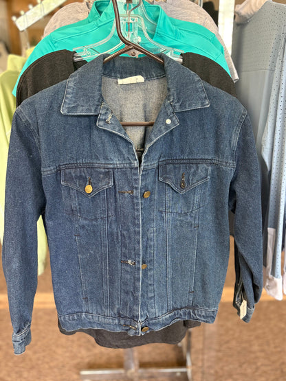 Blue denim jacket on a hanger with a blurred background