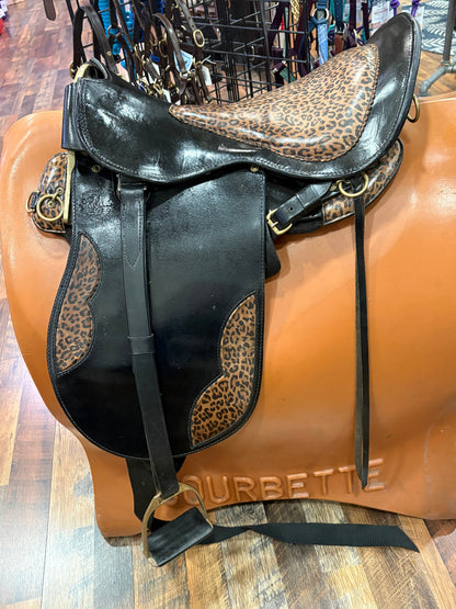 Black leather endurance saddle with leopard print seat and accents.