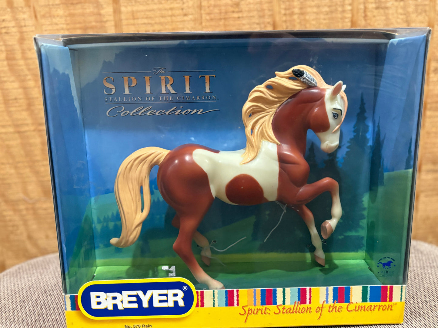 Breyer Spirit of the Cimarron collection toy horse in its original window box packaging, featuring a brown and white pinto horse with a blonde mane and tail.